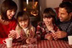 Family playing cards at Christmas
