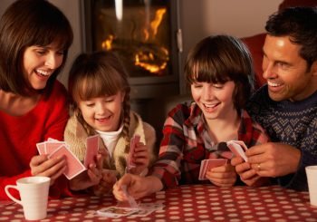 Family playing cards at Christmas