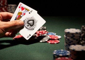Photo of a hand holding the King of Hearts and Ace of Clubs