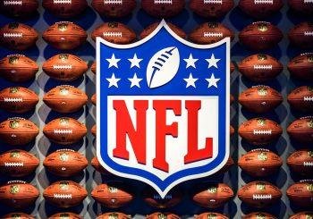 The NFL logo placed against a wall of footballs - fantasy NFL football