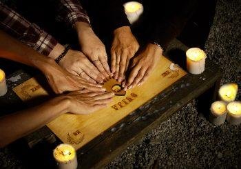 The Ouija Board with people playing it